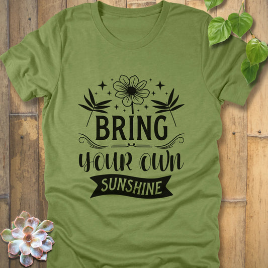 Heather green t-shirt featuring the design "Bring Your Own Sunshine" printed on black letter and flowers