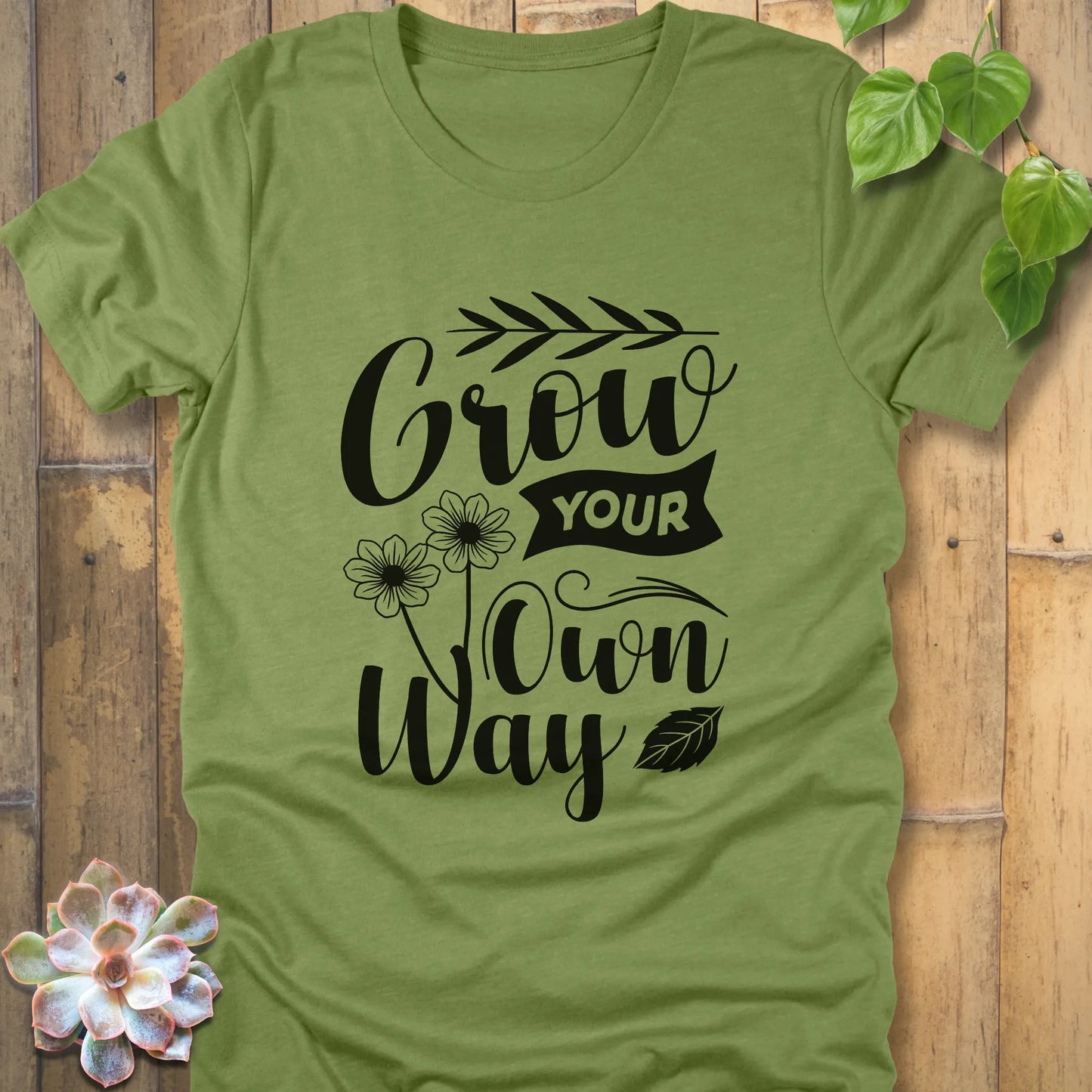 Heather green t-shirt featuring the motivational design Grow your own way, soft breathable cotton graphic tee.
