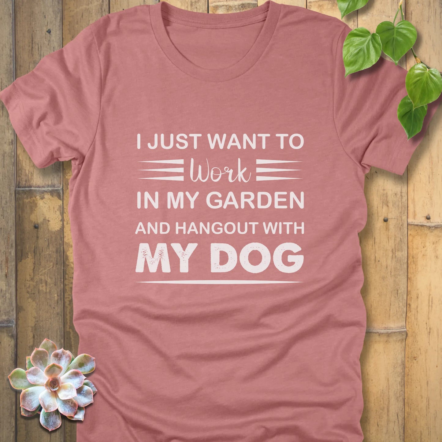 Heather mauve t-shirt featuring the design "I just want to work in my garden and hangout with my dog" printed in white letters
