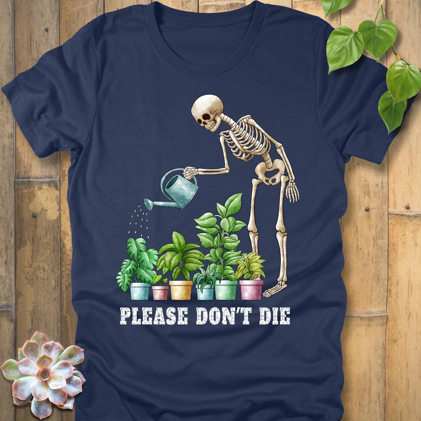 Heather navy t-shirt featuring the design Please Don’t Die with skeleton watering plants print