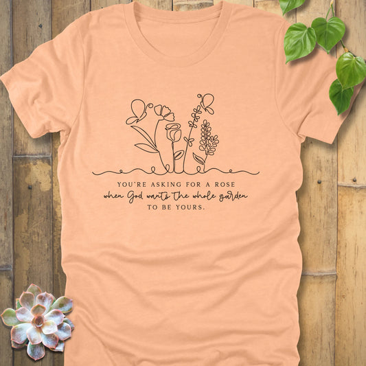 Heather peach t-shirt featuring the design Asking for a rose, printed in black letters, soft pastel cotton shirt