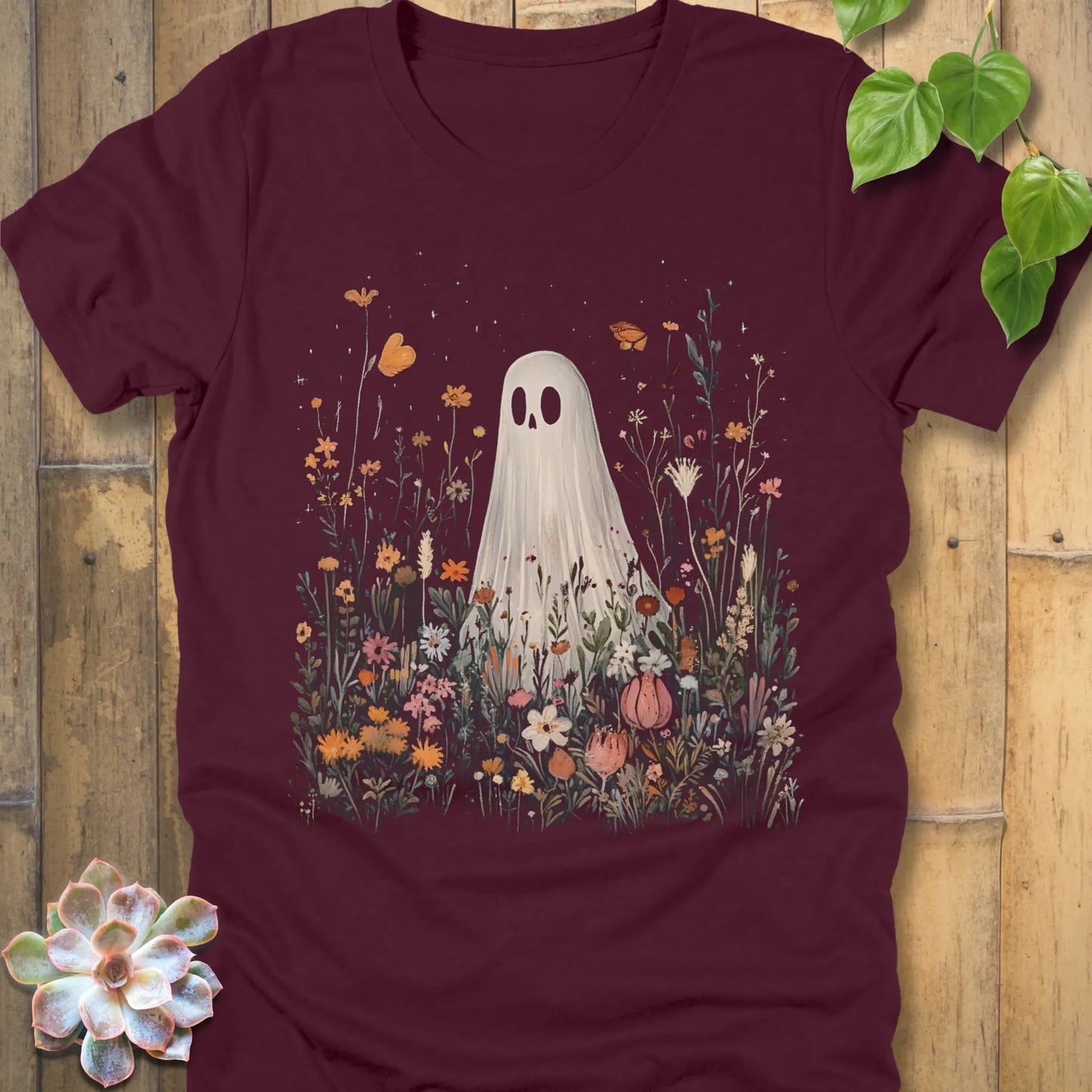 Maroon t-shirt featuring the design Among the Wildflowers printed with a ghost in garden