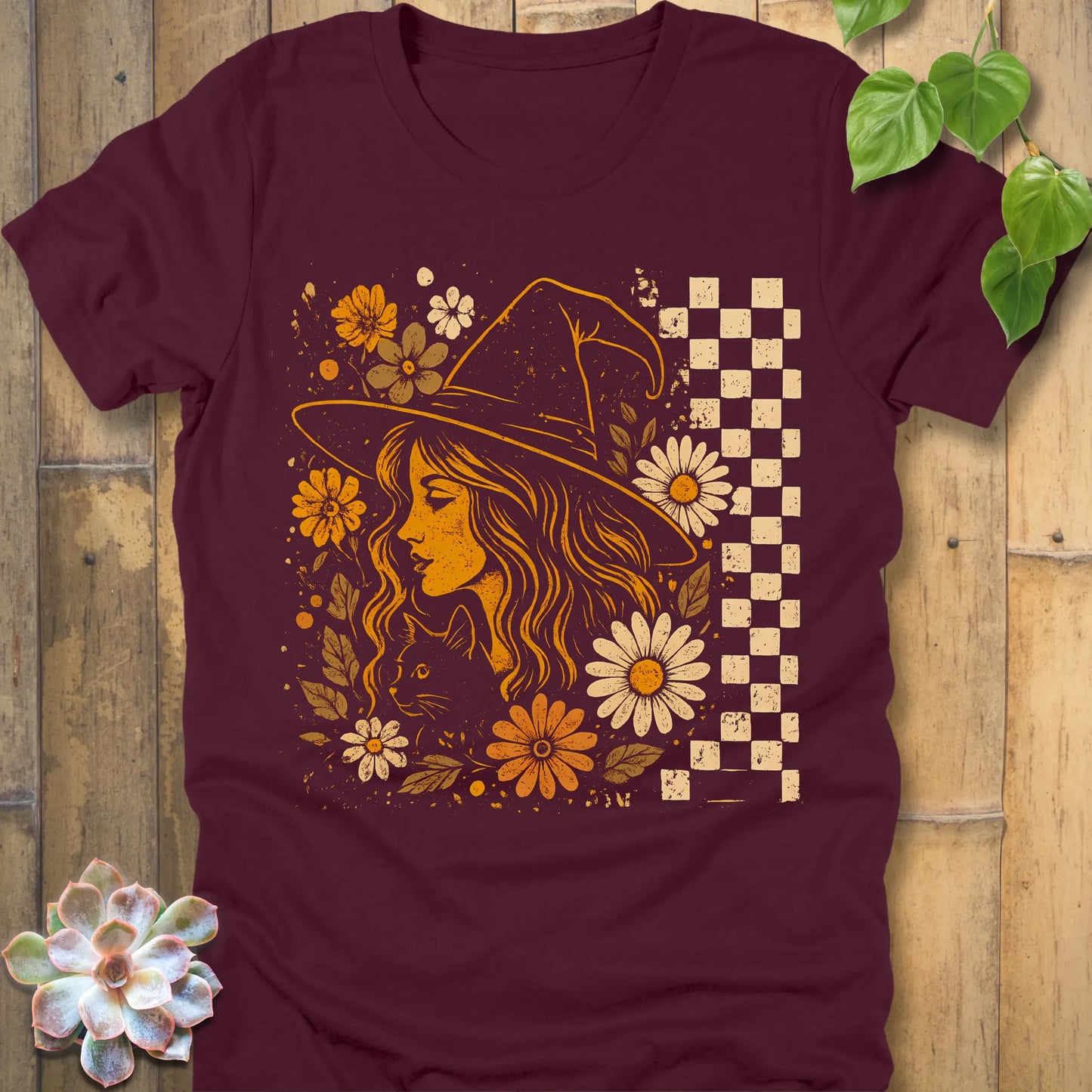 Maroon t-shirt featuring the design Garden Witch Vibes printed with a witch and flowers