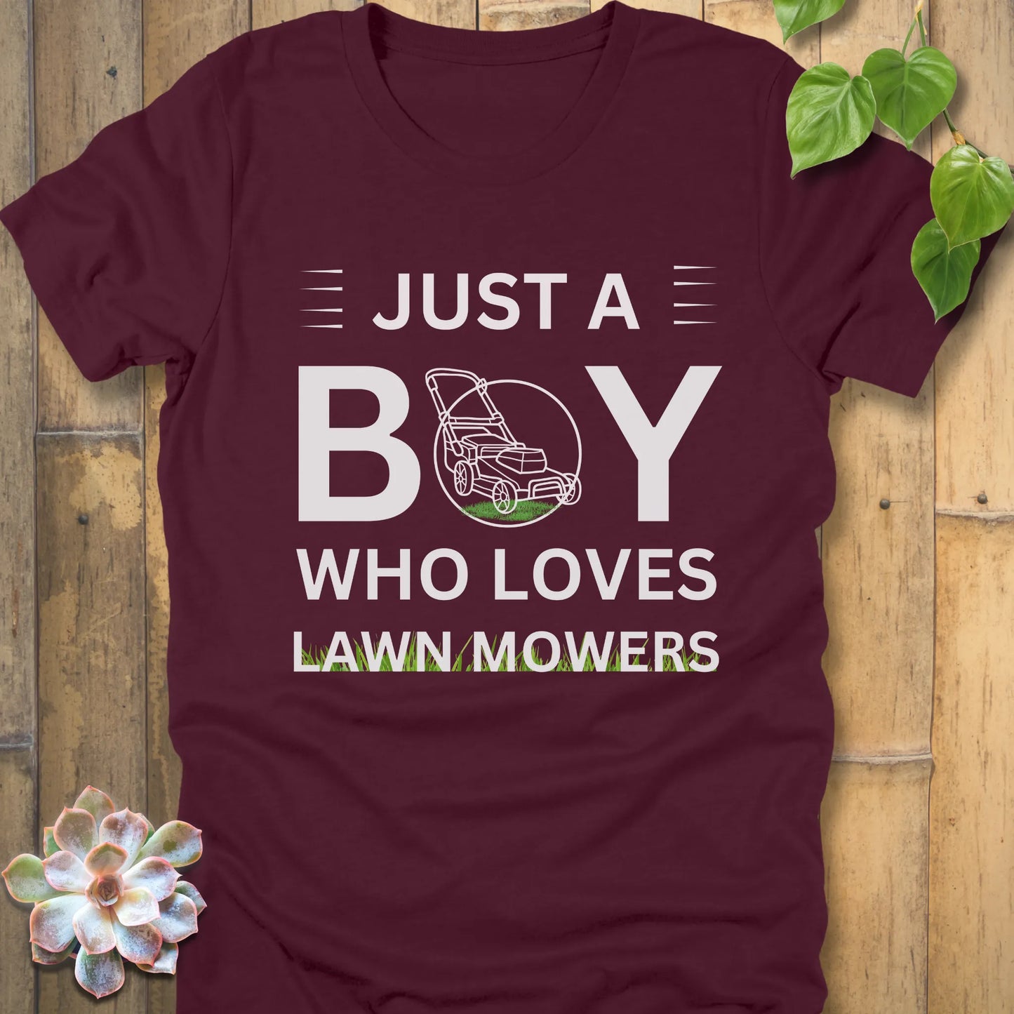 Maroon t-shirt featuring the design Just a Boy who loves lawn mowers printed with a lawn mower in the center