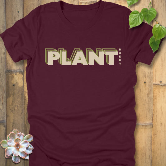 Maroon t-shirt featuring the design Plant Daddy printed in bold letters, soft cotton botanical shirt.