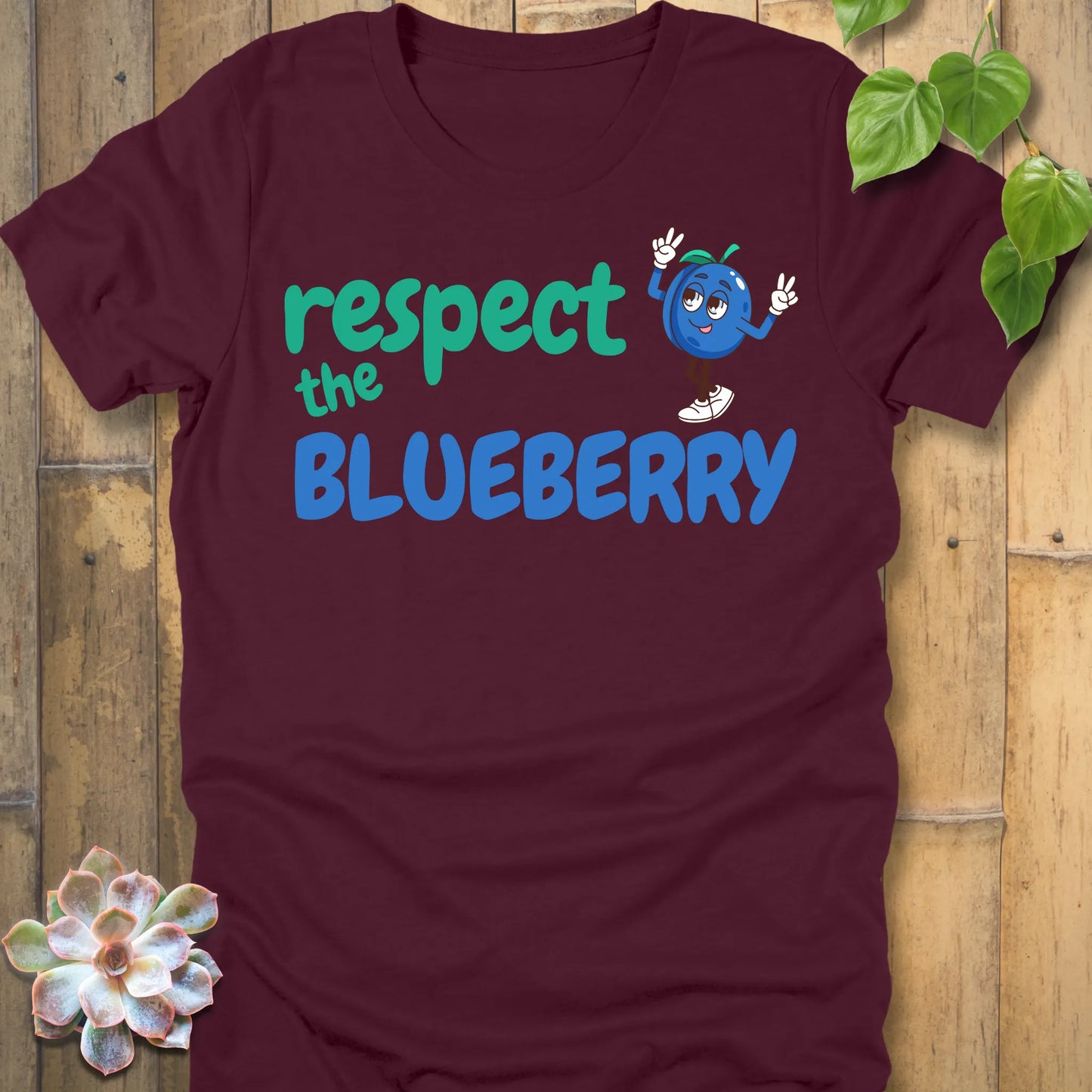Maroon t-shirt featuring the design Respect the Blueberry with a bold blueberry graphic, funny fruit lover shirt.