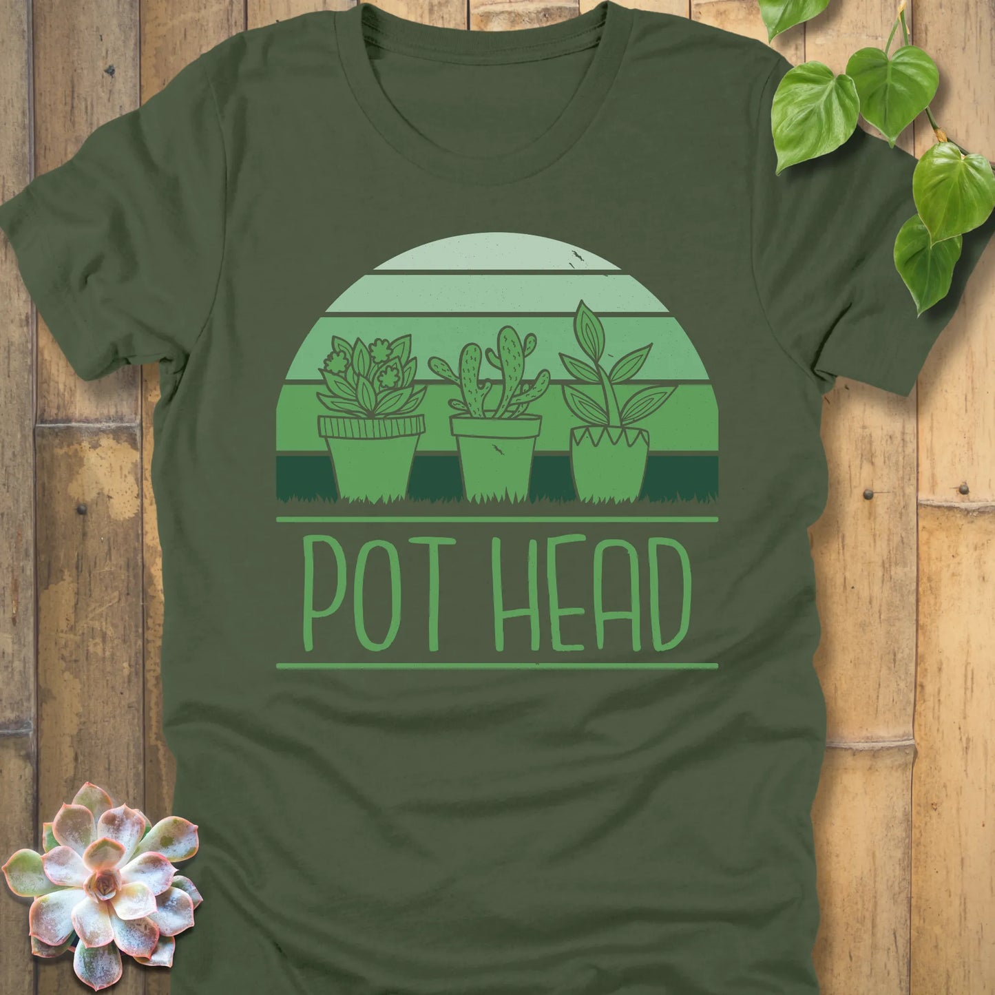 Military Green t-shirt featuring the design Pot Head printed in bold letters and 3 different plant in the pots, funny plant lover shirt.