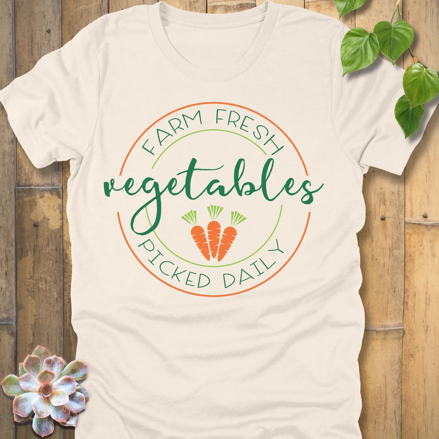 Natural t-shirt featuring the design Fresh Vegetables printed in green letters and some carrots, organic vegetable lover shirt.
