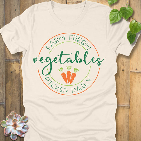 Natural t-shirt featuring the design Fresh Vegetables printed in green letters and some carrots, organic vegetable lover shirt.