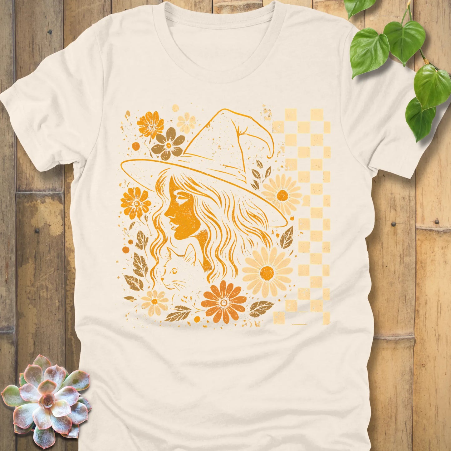 Natural t-shirt featuring the design Garden Witch Vibes printed with a witch and flowers