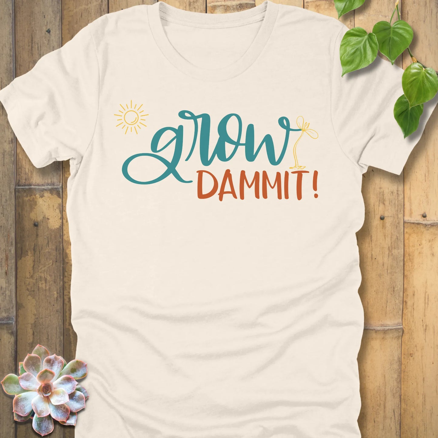 Natural t-shirt featuring the design Grow Dammit printed in bold letters, casual gardening shirt.