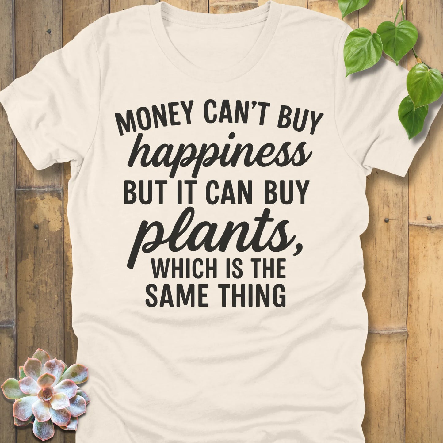 Natural t-shirt featuring the design Money Can’t Buy Happiness printed in bold black letters, motivational quote shirt.