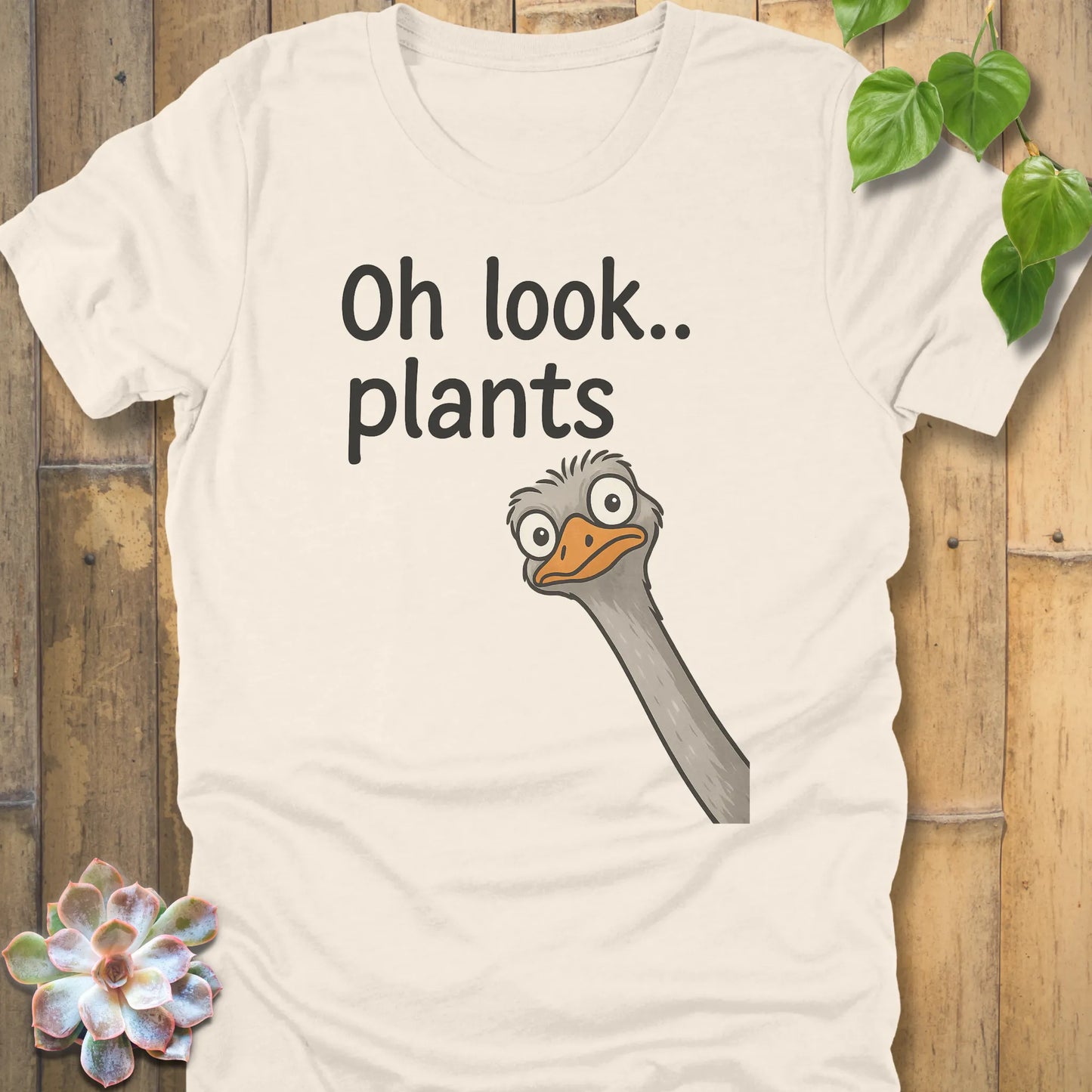 Natural t-shirt featuring the design Oh Look Plants printed in black letters, with animal.