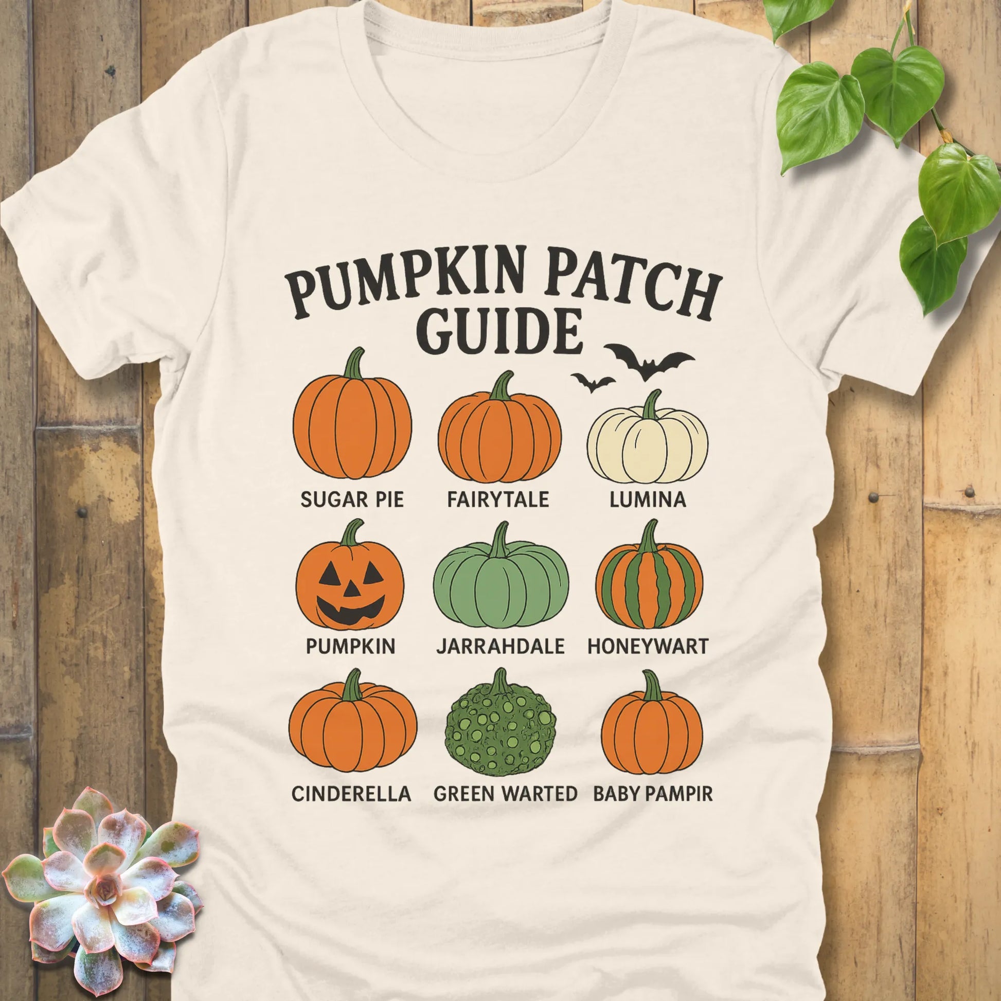 Natural t-shirt featuring the design Pumpkin Patch Guide printed in bold black letters and pumpkin