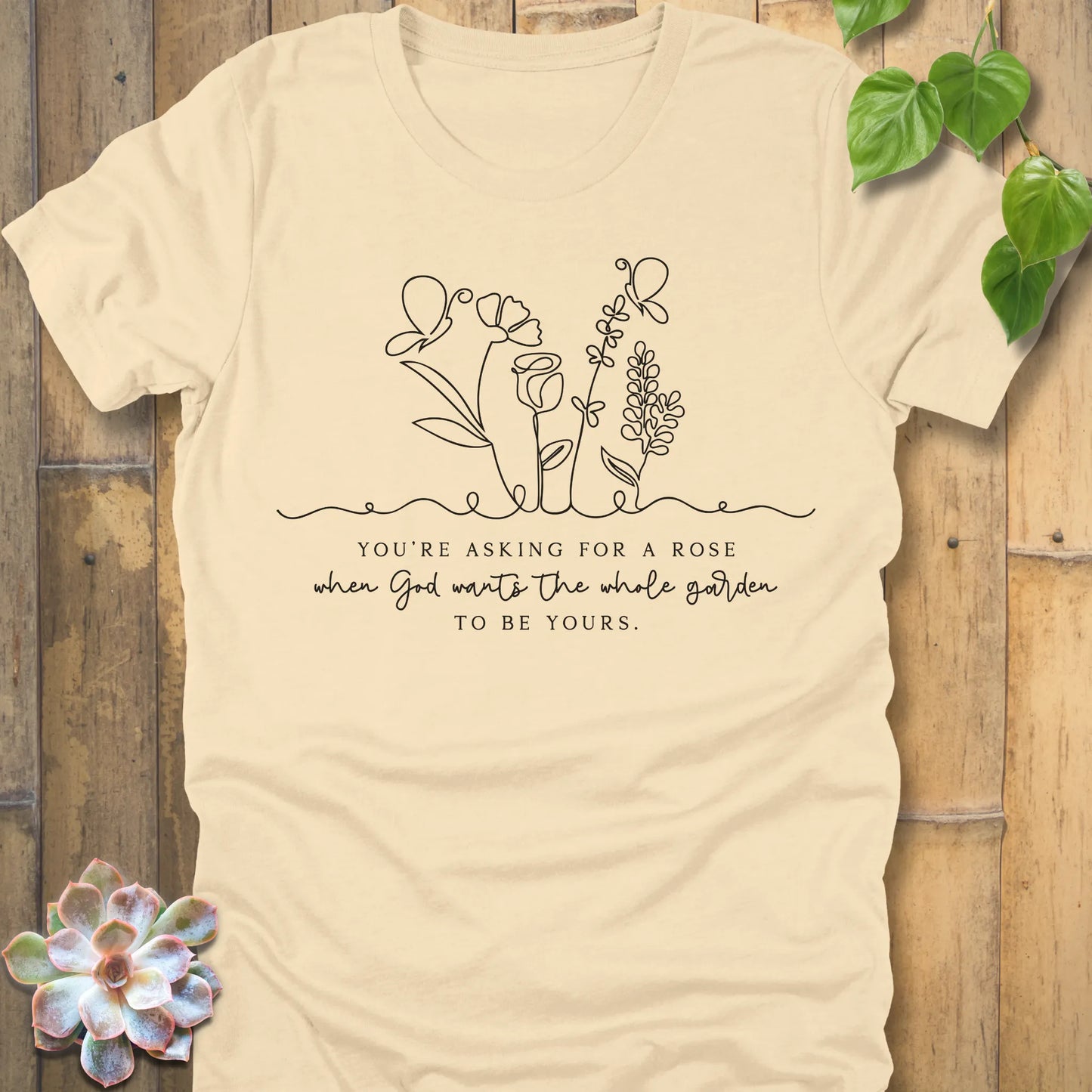 Soft Cream t-shirt featuring the design Asking for a rose, printed in black letters, soft pastel cotton shirt