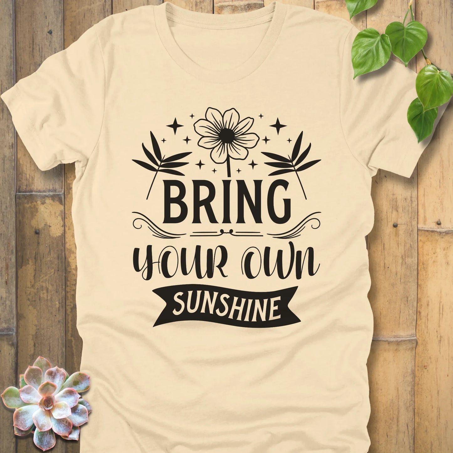 Soft Cream t-shirt featuring the design "Bring Your Own Sunshine" printed in black lette and flower