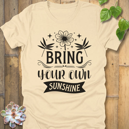 Soft Cream t-shirt featuring the design "Bring Your Own Sunshine" printed in black lette and flower
