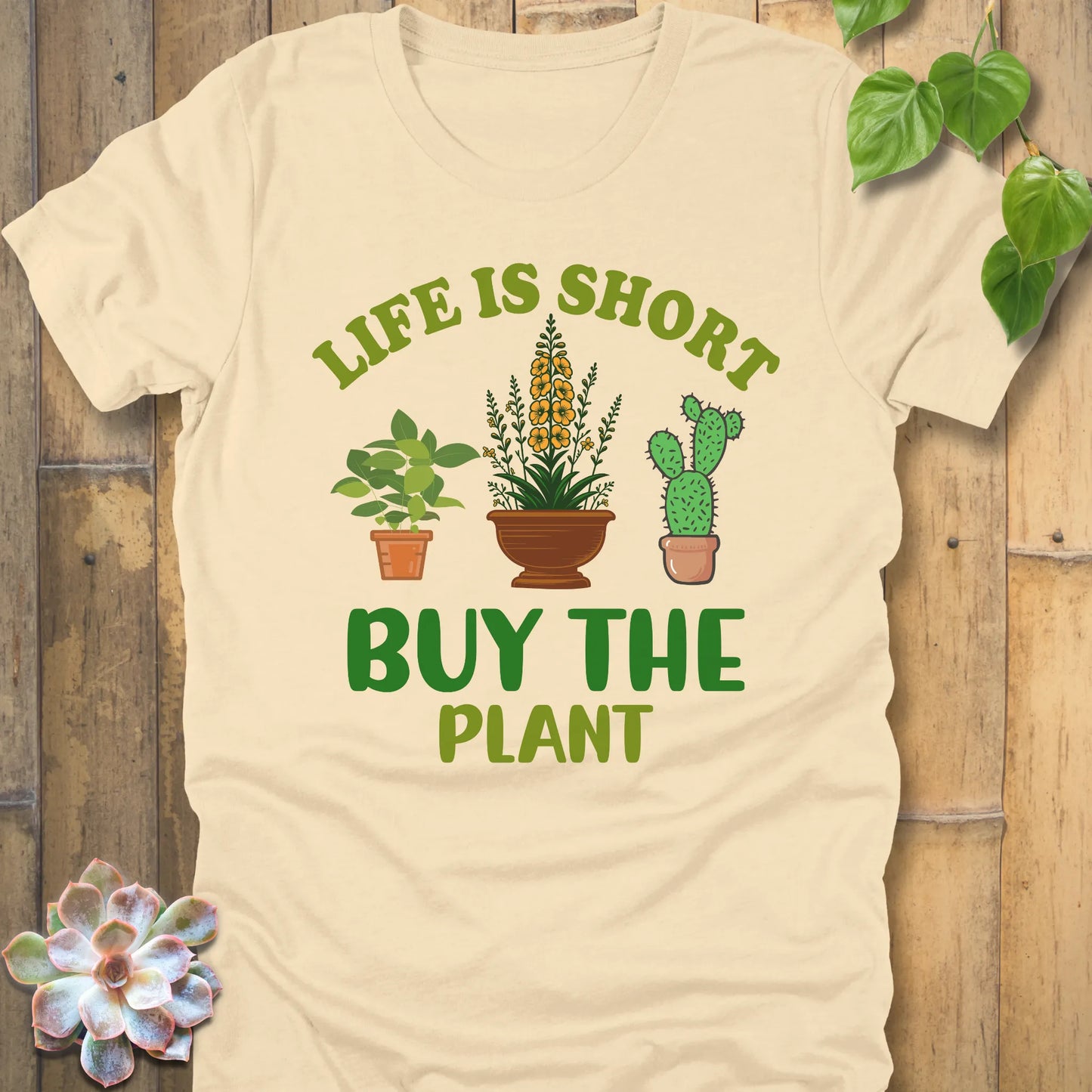 Soft Cream t-shirt featuring the design Life is short, buy the plant printed in green text with plant illustration