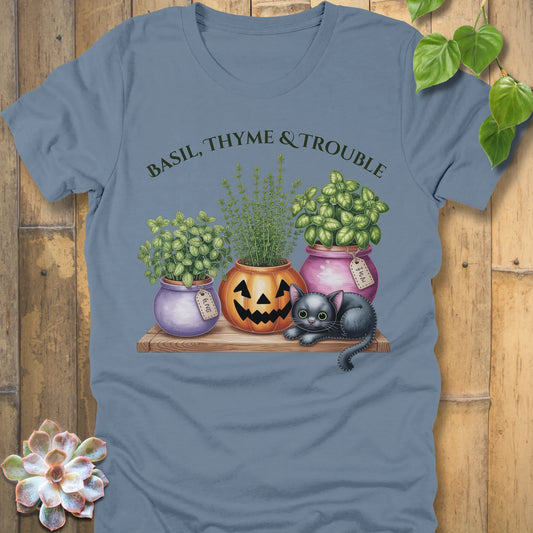 Steel Blue t-shirt featuring the design "Basil, Thyme & Trouble" printed in bold green letters and a plants, cats 