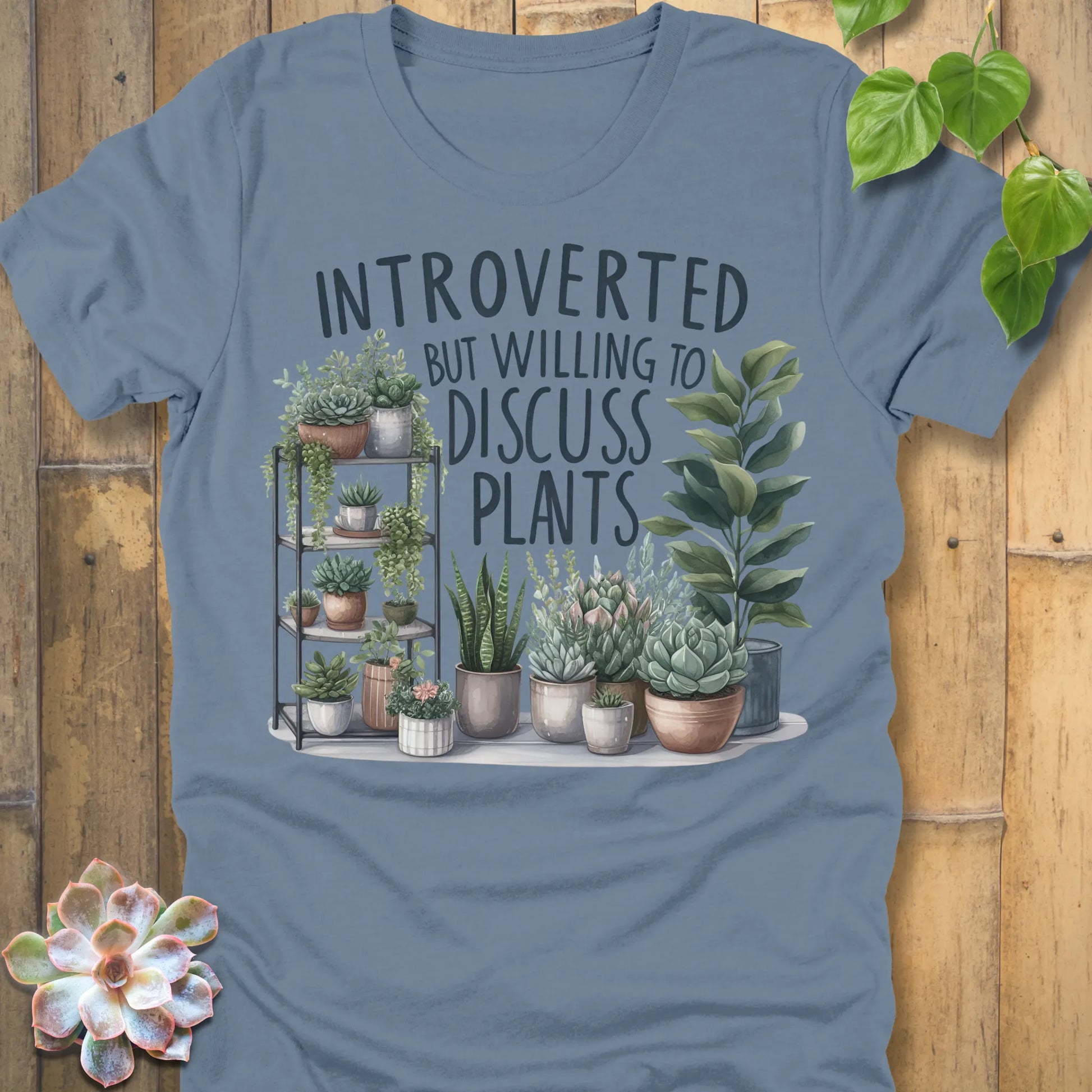 Steel Blue t-shirt featuring the design Willing To Discuss Plants printed in bold black letters, funny plant lover shirt.
